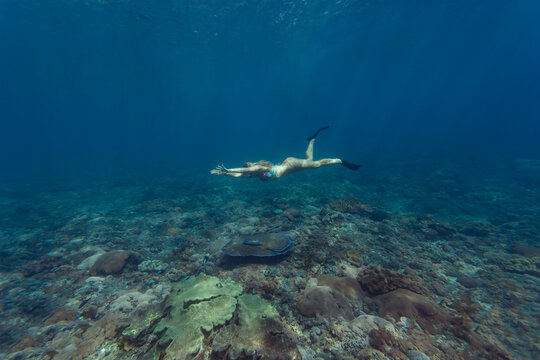 Young woman diving, Nusa Penida island, Bali, Indonesia