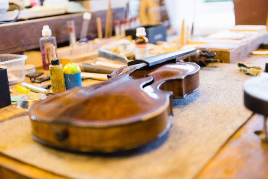 Violin making, violin on workbench