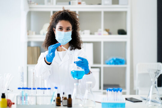 Female doctor testing chemical solution in hospital during COVID-19