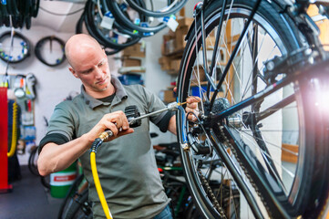 Bicycle mechanic working in bike shop