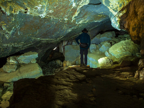 Spain, Basque Country, Euskadi, senior man viewing rocks in Baltzola cave