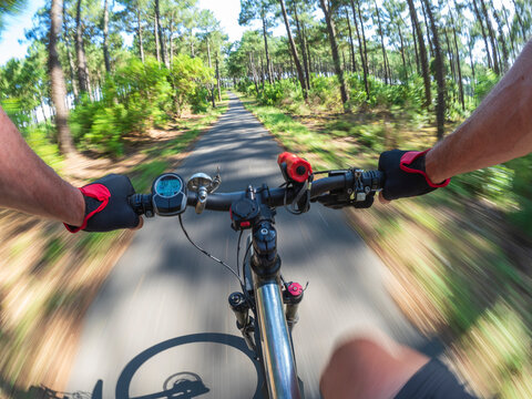 France, Landes, senior man on e-bike in the forest - Powered by Adobe