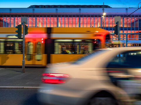 Blurred motion of vehicles moving on road against Palace of culture at dusk, Dresden, Germany
