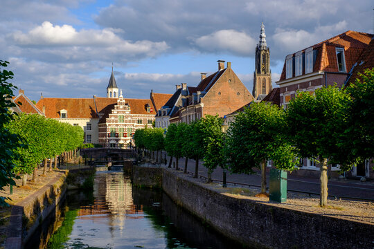 Netherlands, Utrecht, Amersfoort, Row of trees along river Eem canal with history museum in background