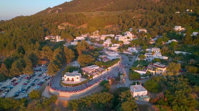 Aerial view approaching crowded Zia street during golden hour