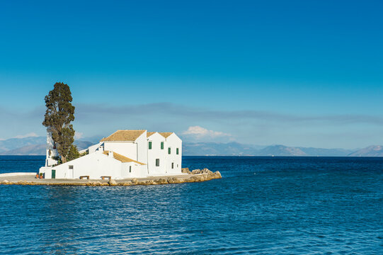 Vlacherna Monastery amidst sea against blue sky at Kanoni, Ionian Islands, Greece