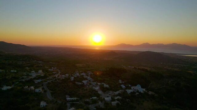 Pullback aerial reveal of sunset over Zia village, Kos, Greece
