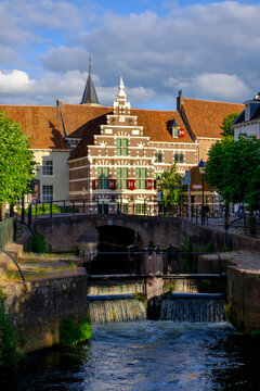 Netherlands, Utrecht, Amersfoort, Arch bridge over river Eem canal with history museum in background