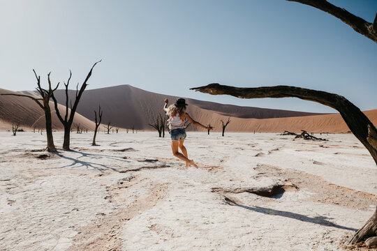 Namibia, Namib desert, Namib-Naukluft National Park, Sossusvlei, woman moving in Deadvlei