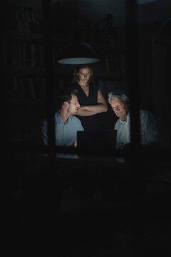 Team of business people working late in office, disussing solutions