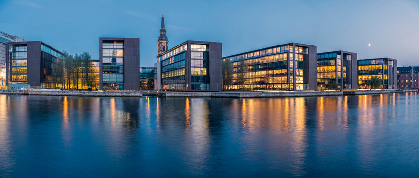 Denmark, Copenhagen, Panorama of Christianshavn district waterfront at dusk