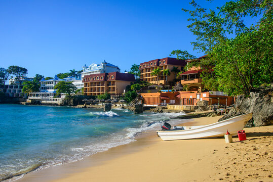 Boats moored at beach against clear blue sky in Sos&Ocirc;&oslash;&Omega;a, Dominican Republic