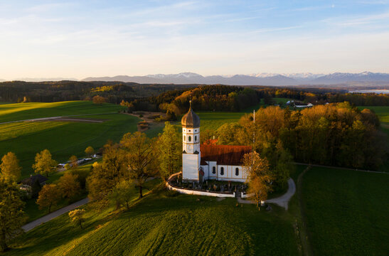 Aerial view over Church St. Johann Baptist at dawn, Holzhausen near Munsing, Bavaria, Germany