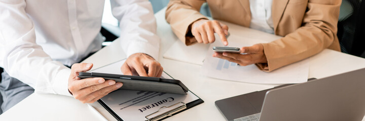 two coworkers helping each other to revise the contract before signing signature carefully with the hygienic protection