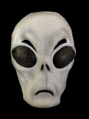 Alien Mask with Bulging Eyes Isolated Against Black Background