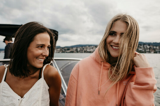Happy female friends on a boat trip on a lake