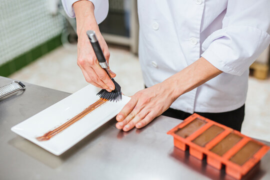 Junior chef prepairing a dessert on plate