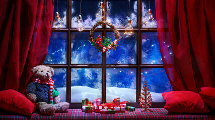 christmas cozy interior background with window sill illuminated with lights and teddy bear toy