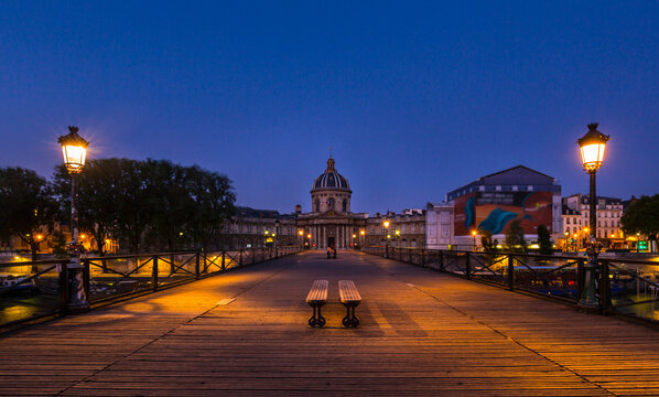Bridge leading to dome of Pont des arts against clear blue sky at sunset, Paris, France