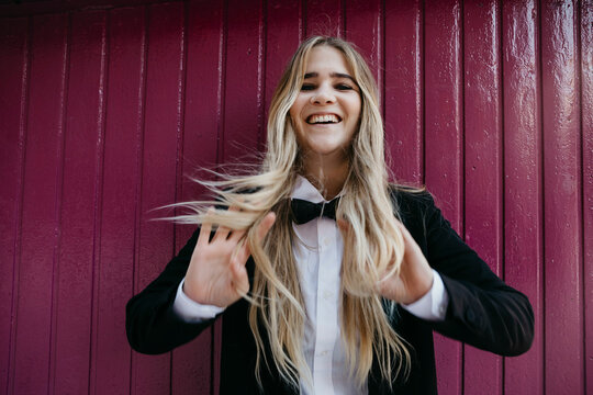 Portrait of laughing blond woman wearing black tie and blazer