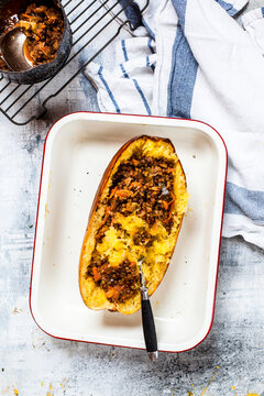 Baked spaghetti squash with vegan bolognese sauce made from lentils, leeks, and carrots
