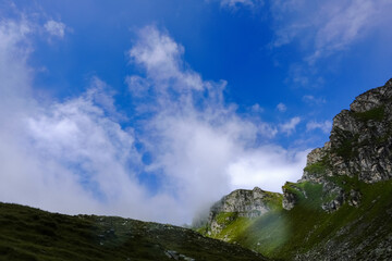 fog and blue sky while hiking in the mountains