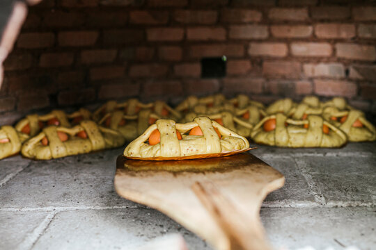 Close-up of Mona De Pascua on pizza peel in wood burning stove
