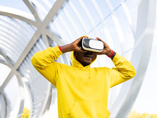 Sportsman using virtual reality headset while standing at elevated walkway