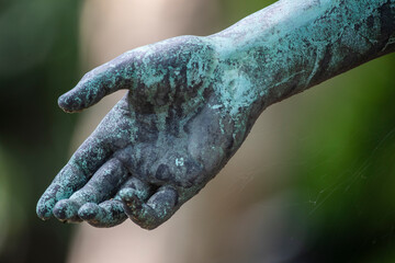 Weathered arm of bronze statue