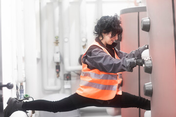 Technician doing the splits in the boiler room