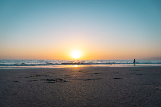 USA, California, Los Angeles, Clear sky over sandy coastal beach of Pacific Ocean at sunset