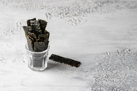 Crispy Seaweed snack on the glass. Nori chips have many  benefits for human health