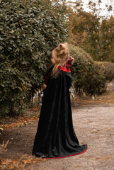 Fototapeta premium a girl in a witch costume for Halloween depicts fear and horror