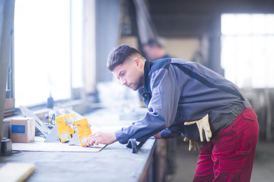 Skilled worker, working in conveyor belt shop