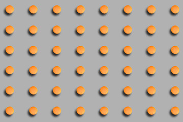 A pattern with orange macarons with a shadow on a gray background. Background with French dessert.