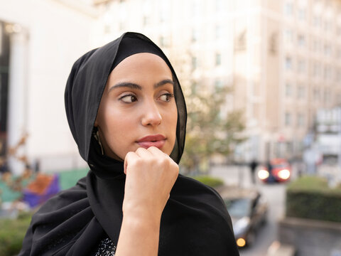 Portrait of young beautiful woman wearing black hijab