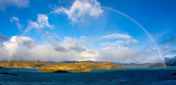 Chile, Ultima Esperanza Province, Scenic panorama of rainbow over shore of Lake Pehoe