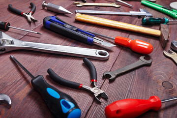 New and old of repairman tools for house work on wooden background.