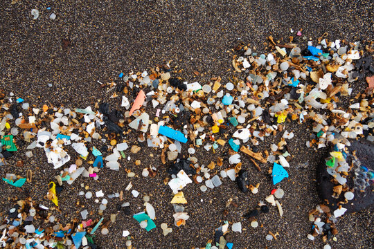 Spain, Canary Islands, Lanzarote, Playa Famara, microplastics, washed up on dark lava sand