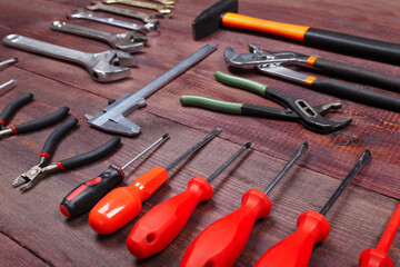 Fototapeta premium New and rusty of serviceman tools for repair work on wooden background.