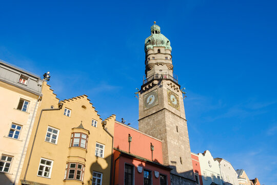 Low angle view of Stadtturm against blue sky in Innsbruck, Austria