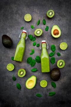 Green smoothie with avocado, spinach, kiwi and lime, coconut flakes and black sesame