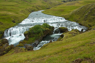 Fototapeta na wymiar Waterfall Steinbogafoss over Skogafoss on Iceland, Europe 