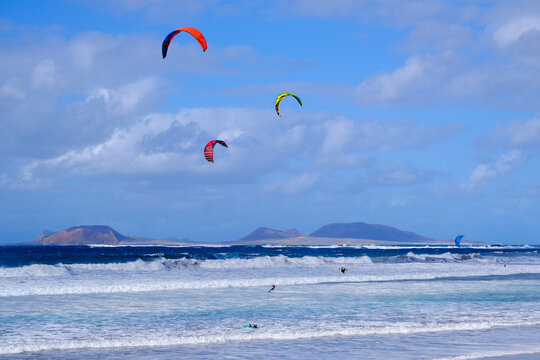 Spain, Canary Islands, Caleta de Famara, Kiteboarders surfing near coast