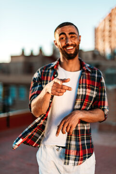 Man gesturing while standing at rooftop in city