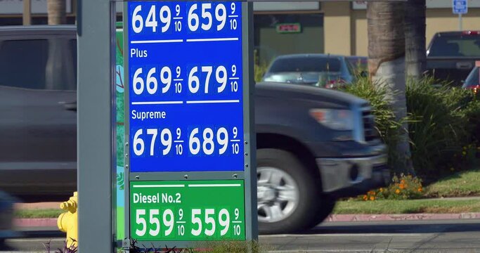 Los Angeles gas stations indicate record high gas prices at the pump in 2021. Cars traffic during rush hour, 4K