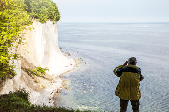 Germany, Mecklenburg-Western Pomerania, Ruegen, Jasmund National Park, chalk cliff, hiker photographing on viewpoint