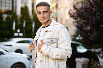 Portrait of handsome young casual man walking on the street