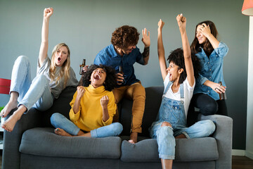 Excited fans watching tv and cheering