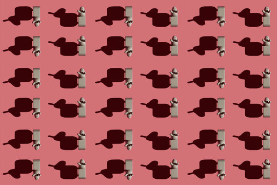 Pattern of small brown donkey figurines against pastel red background
